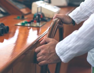 Young captain steering a boat