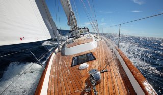 Front view of Hallberg Rassy 55 sailing in the sun 